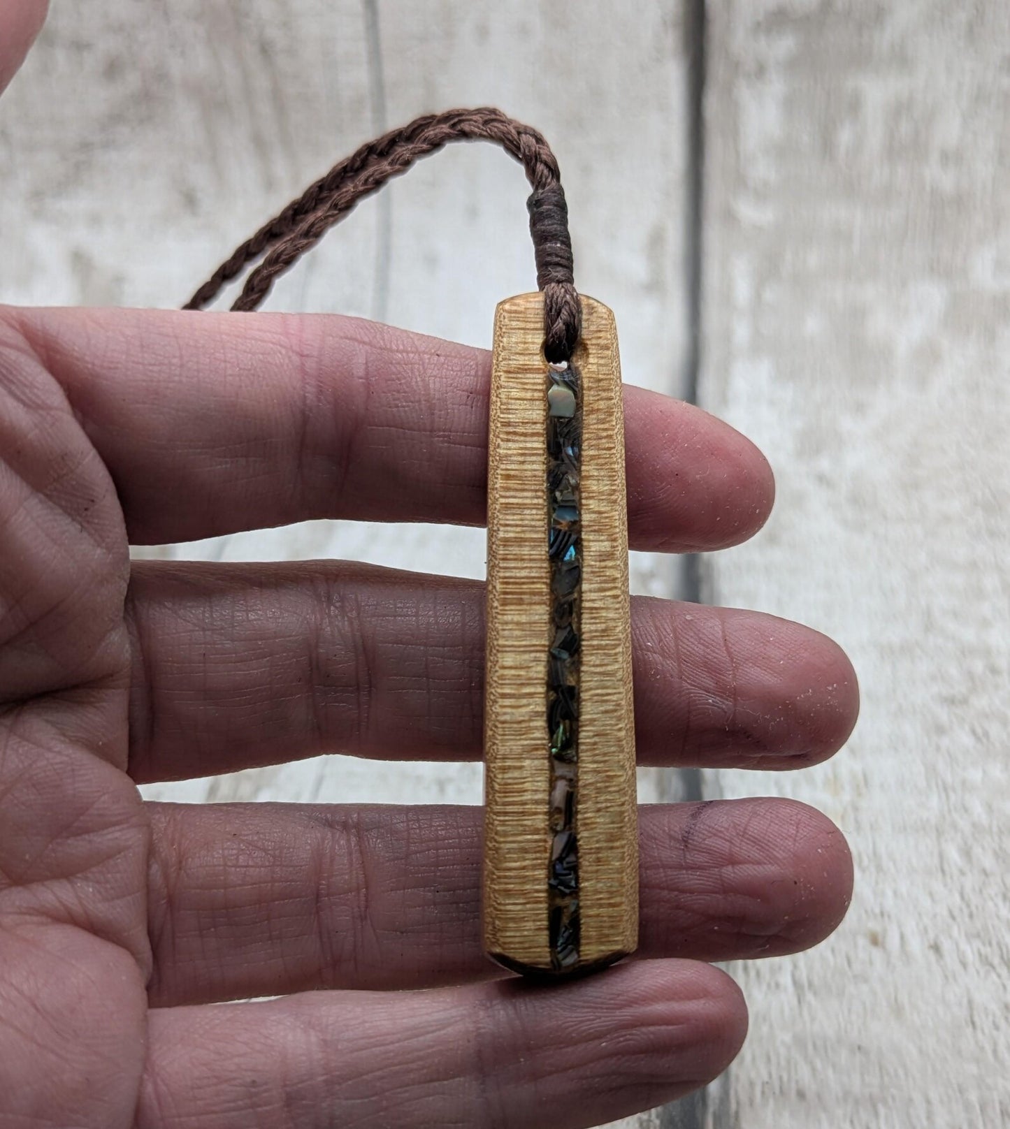 NZ Swamp Kauri wood pendant with rainbow pāua shell.