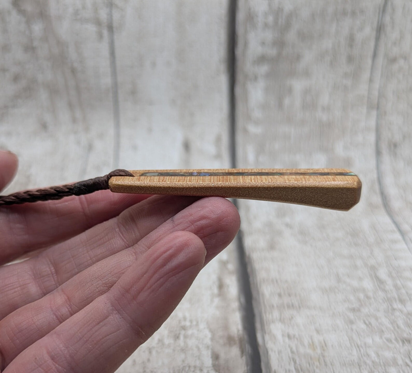 NZ Swamp Kauri wood pendant with rainbow pāua shell.