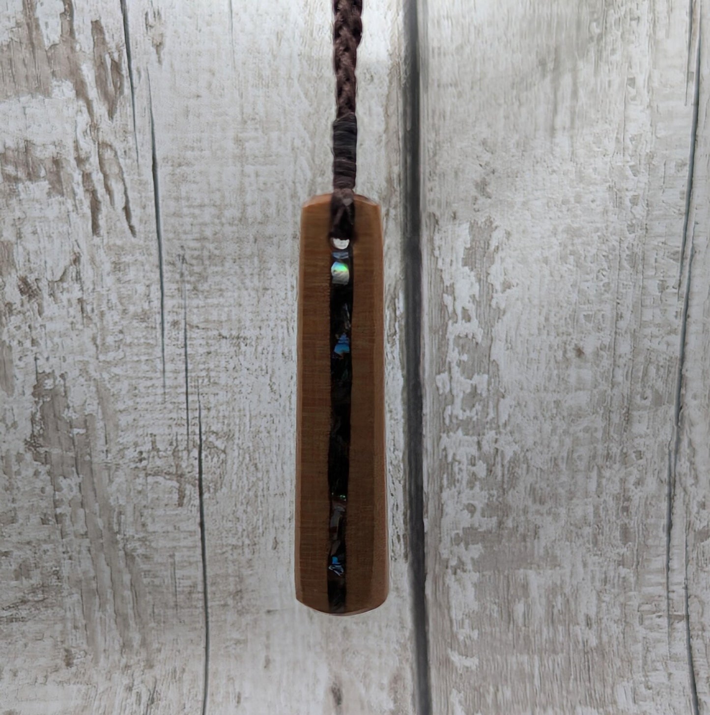 NZ Swamp Kauri wood pendant with rainbow pāua shell.
