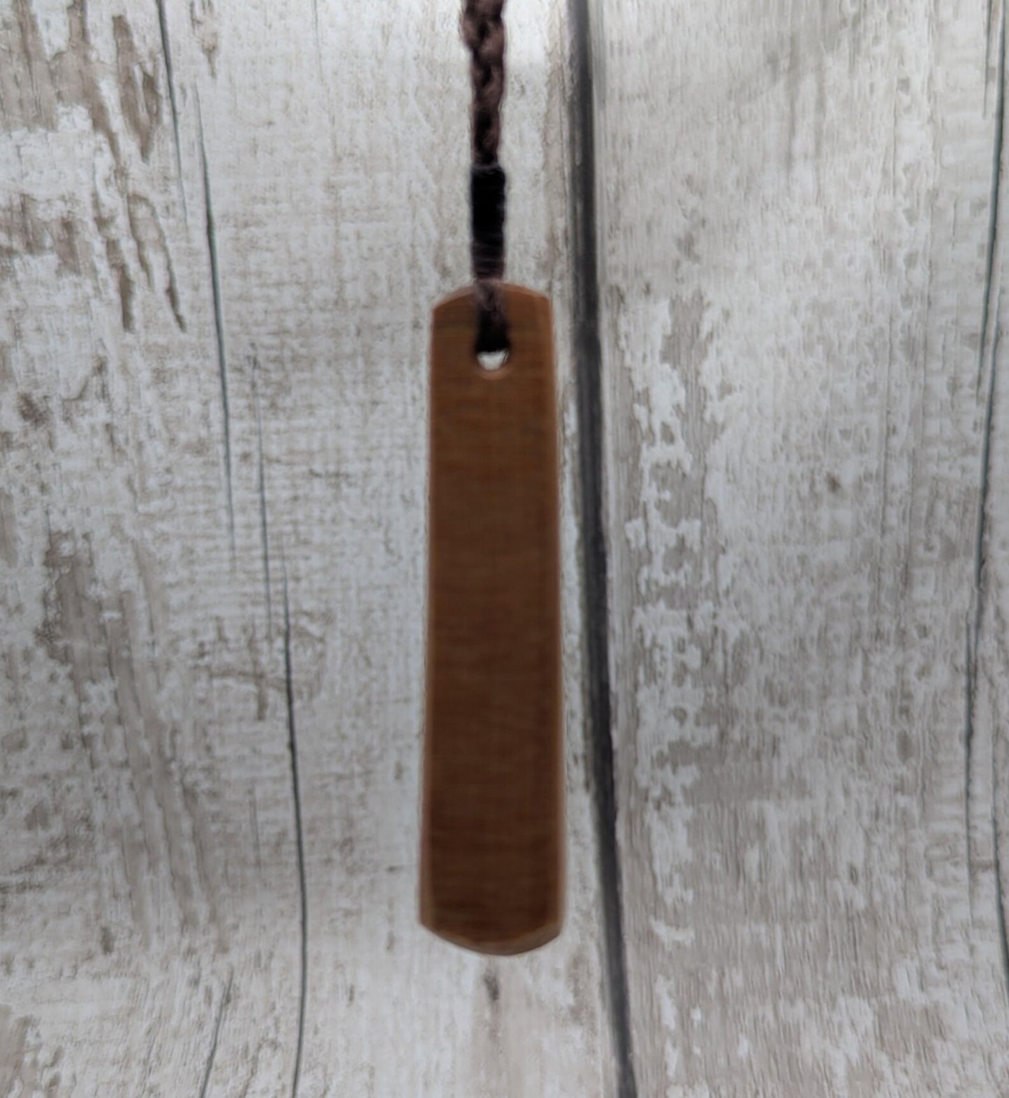 NZ Swamp Kauri wood pendant with rainbow pāua shell.