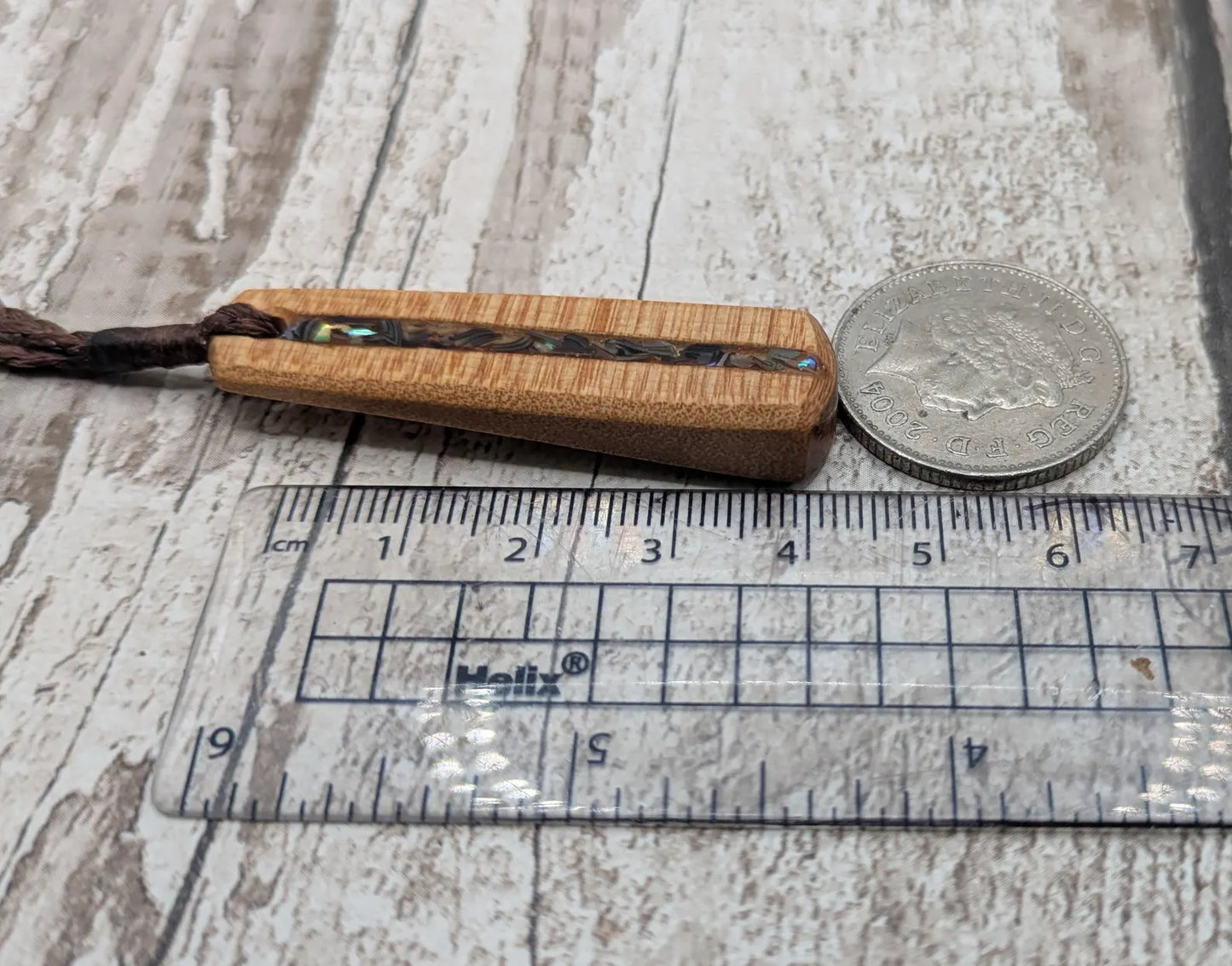New Zealand swamp kauri with Rainbow Pāua shell.