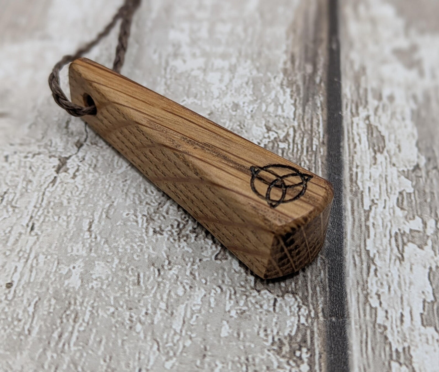 Whiskey barrel oak roimata tear drop triskele pendant.