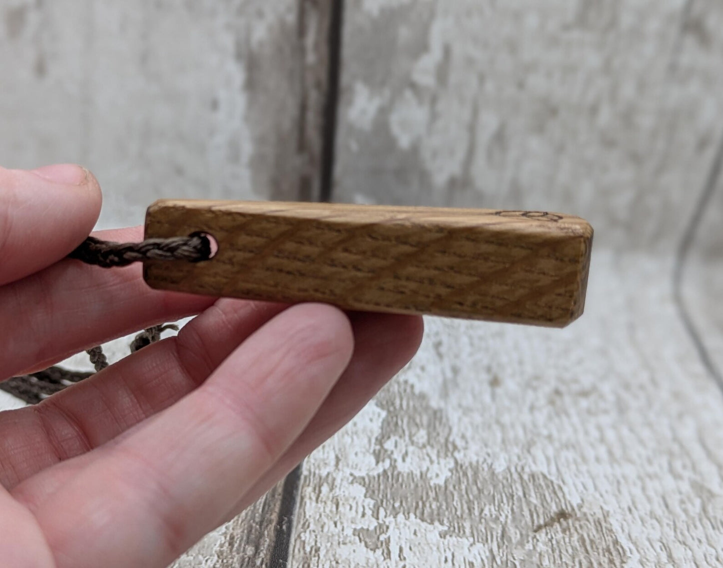 Whiskey barrel oak roimata tear drop triskele pendant.
