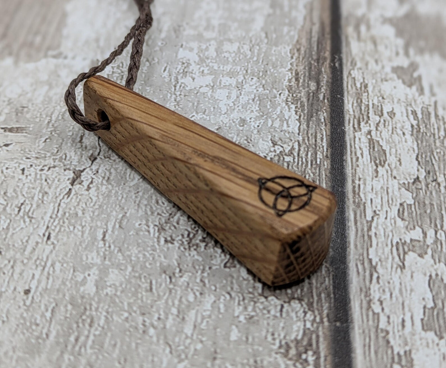 Whiskey barrel oak roimata tear drop triskele pendant.