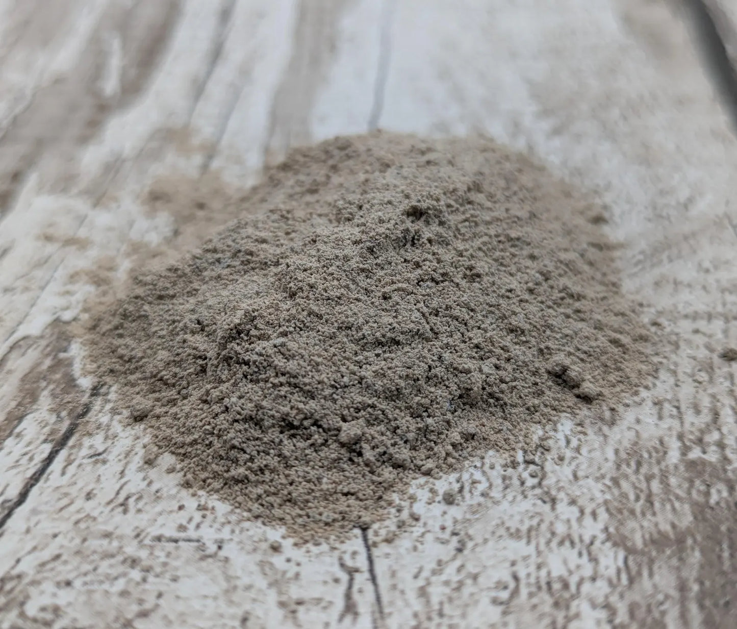 Unrefined powdered brown periwinkle shell paint pigment.