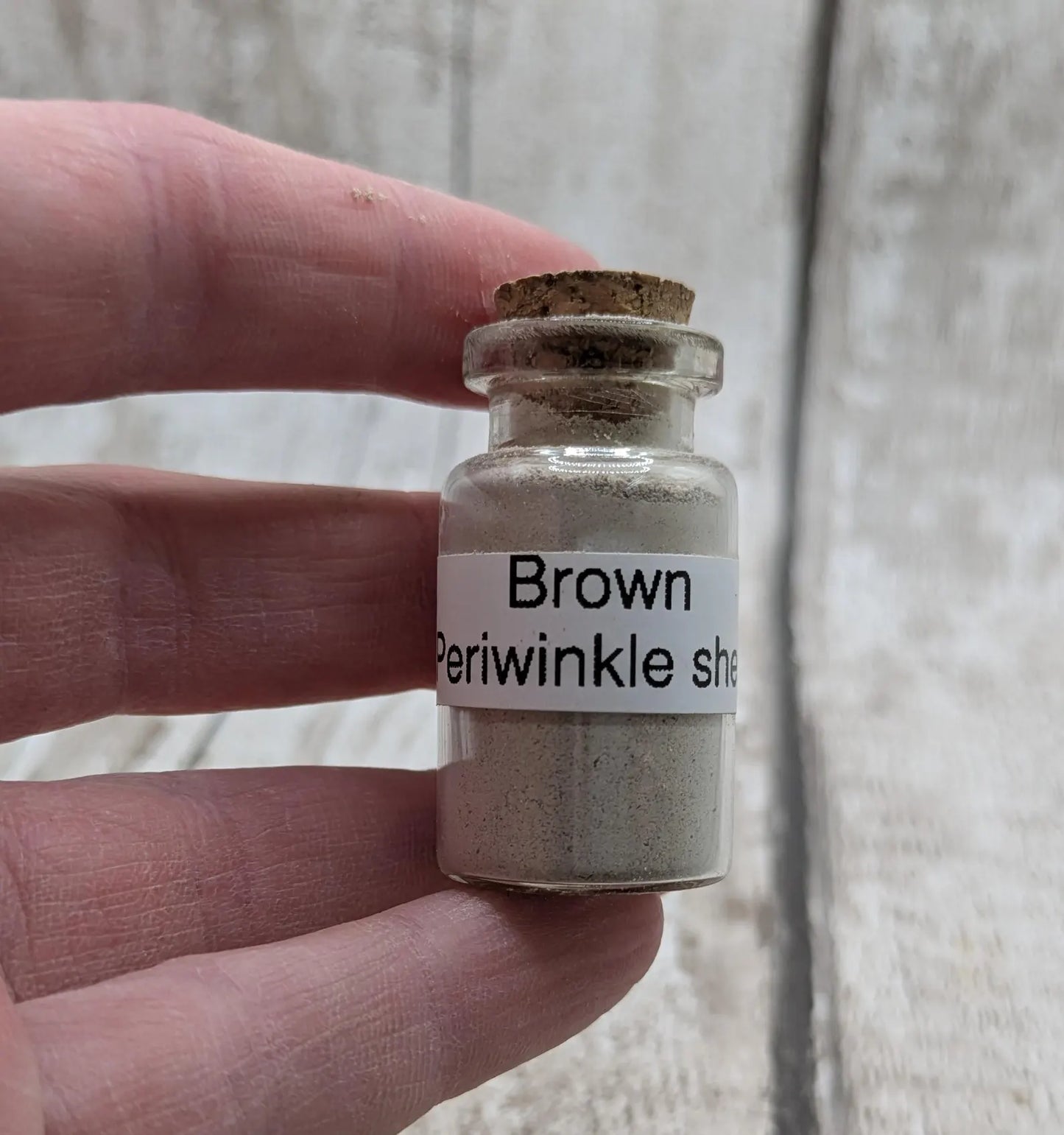 Unrefined powdered brown periwinkle shell paint pigment.