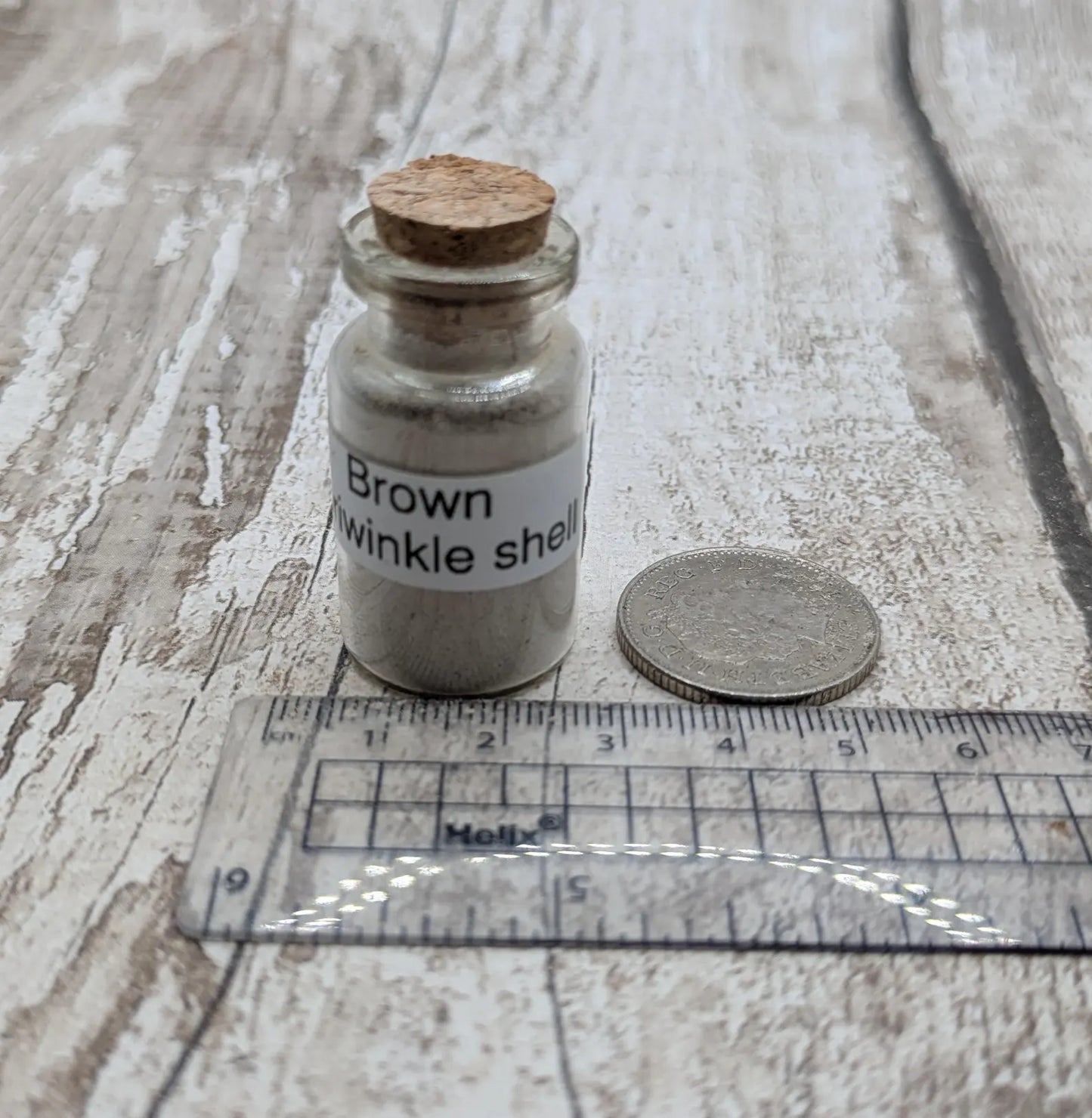Unrefined powdered brown periwinkle shell paint pigment.