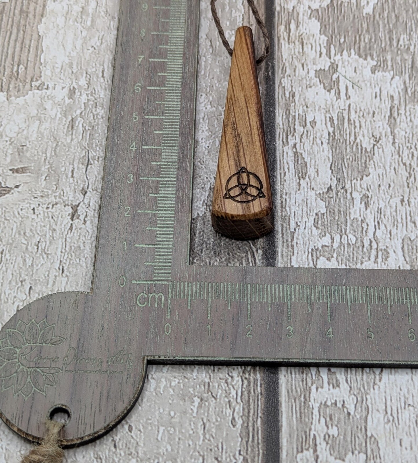 Whiskey barrel oak roimata tear drop triskele pendant.