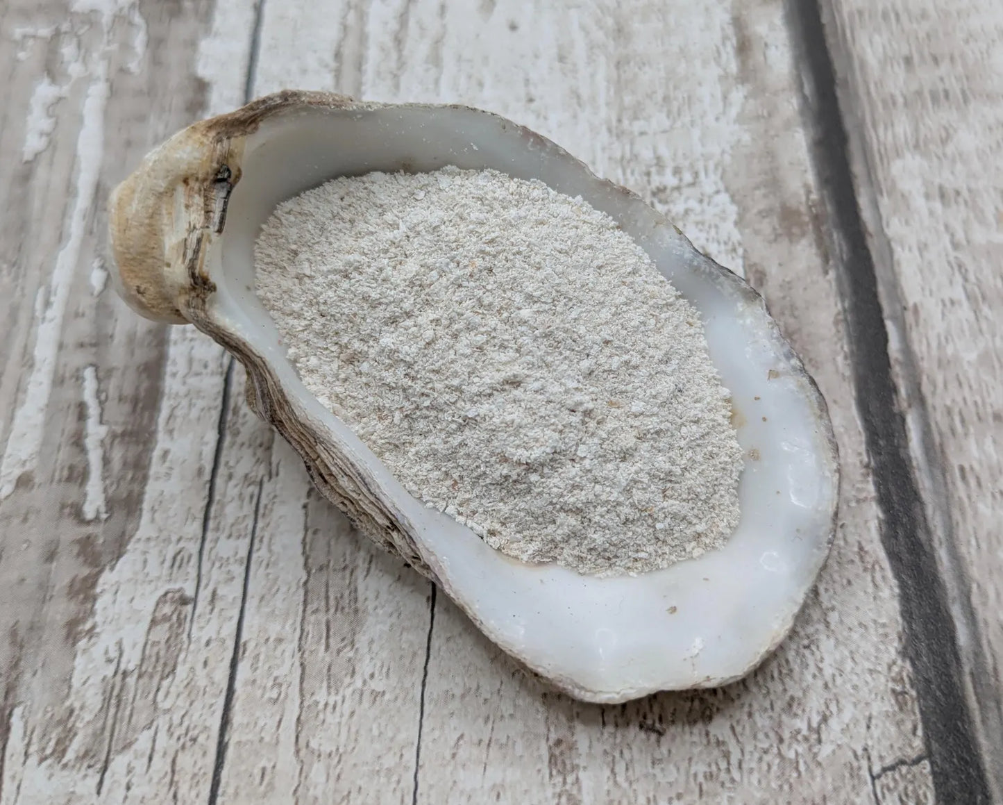 Unrefined powdered peach native oyster shell paint pigment.