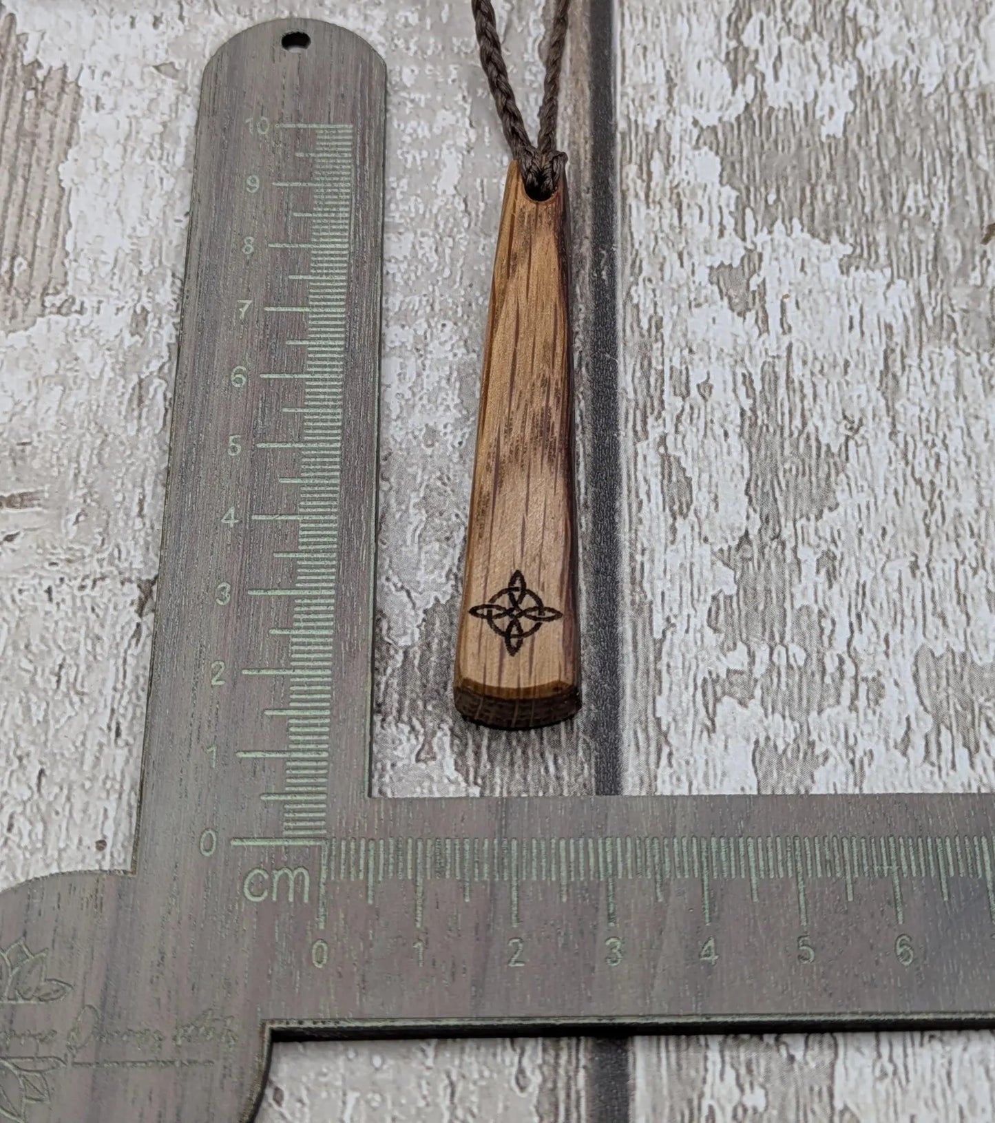 Whiskey barrel oak tear drop pendant with laser printed with rune symbol.