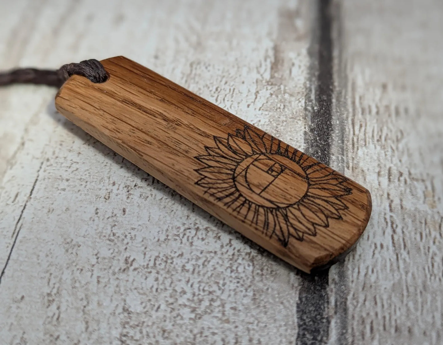 Oak wood pendant with sunflower laser print.