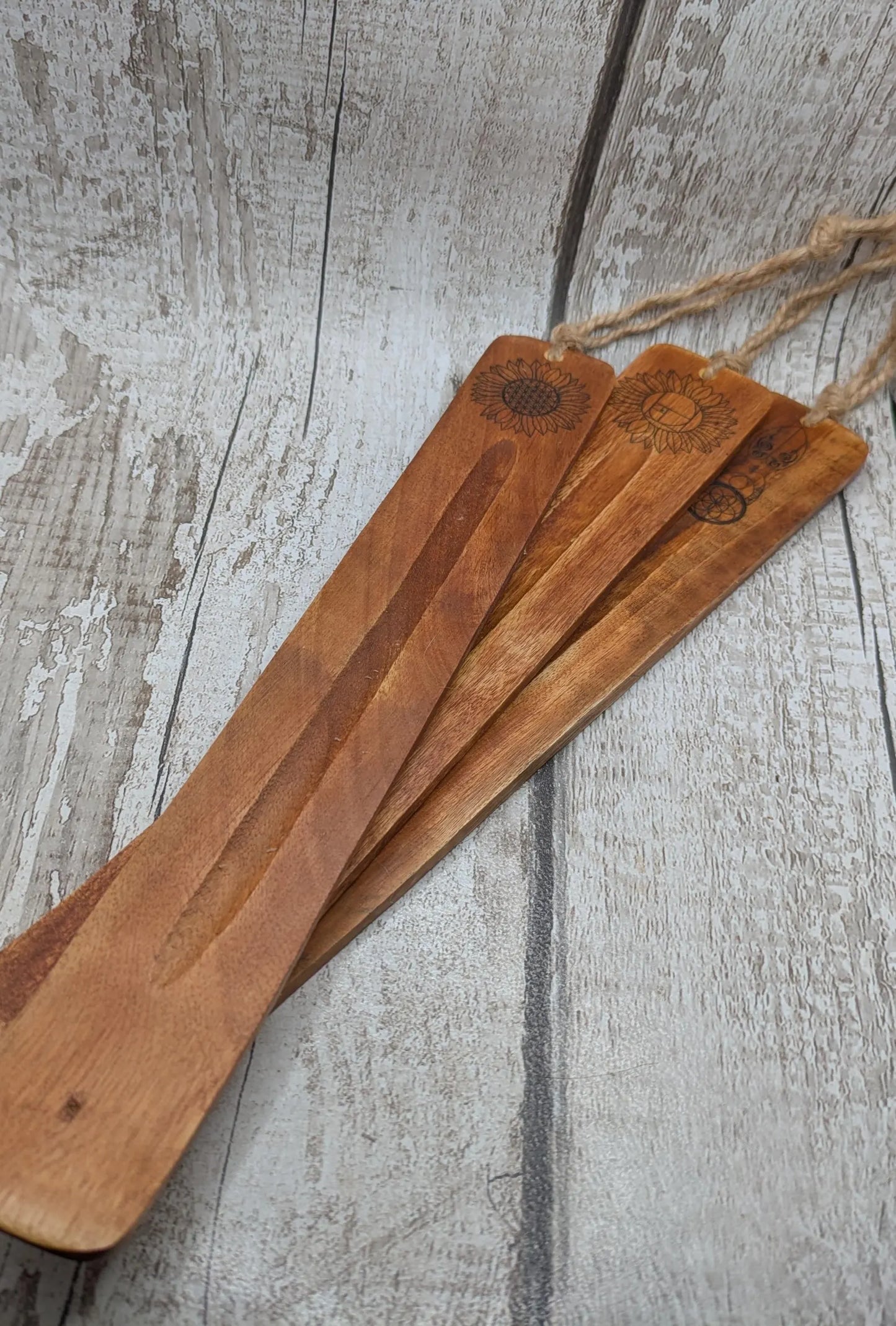 Recycled mango wood laser printed incense stick holders.