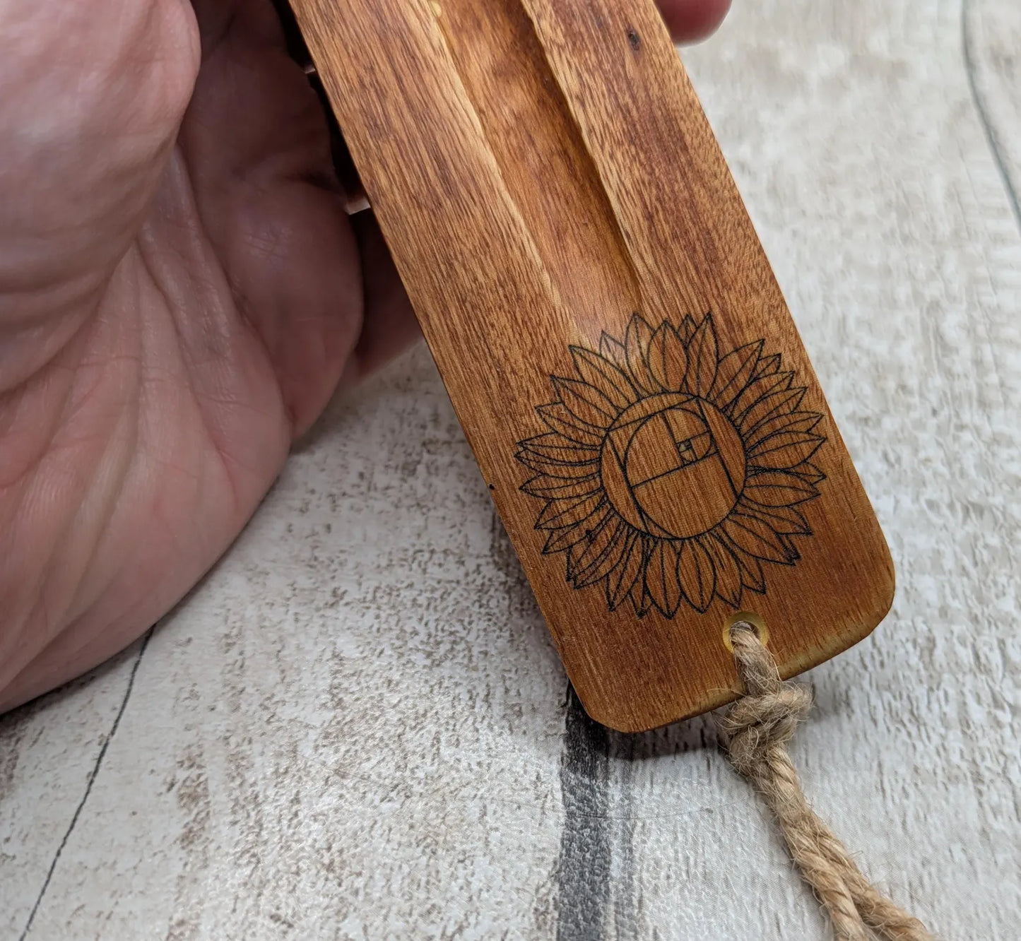 Recycled mango wood laser printed incense stick holders.