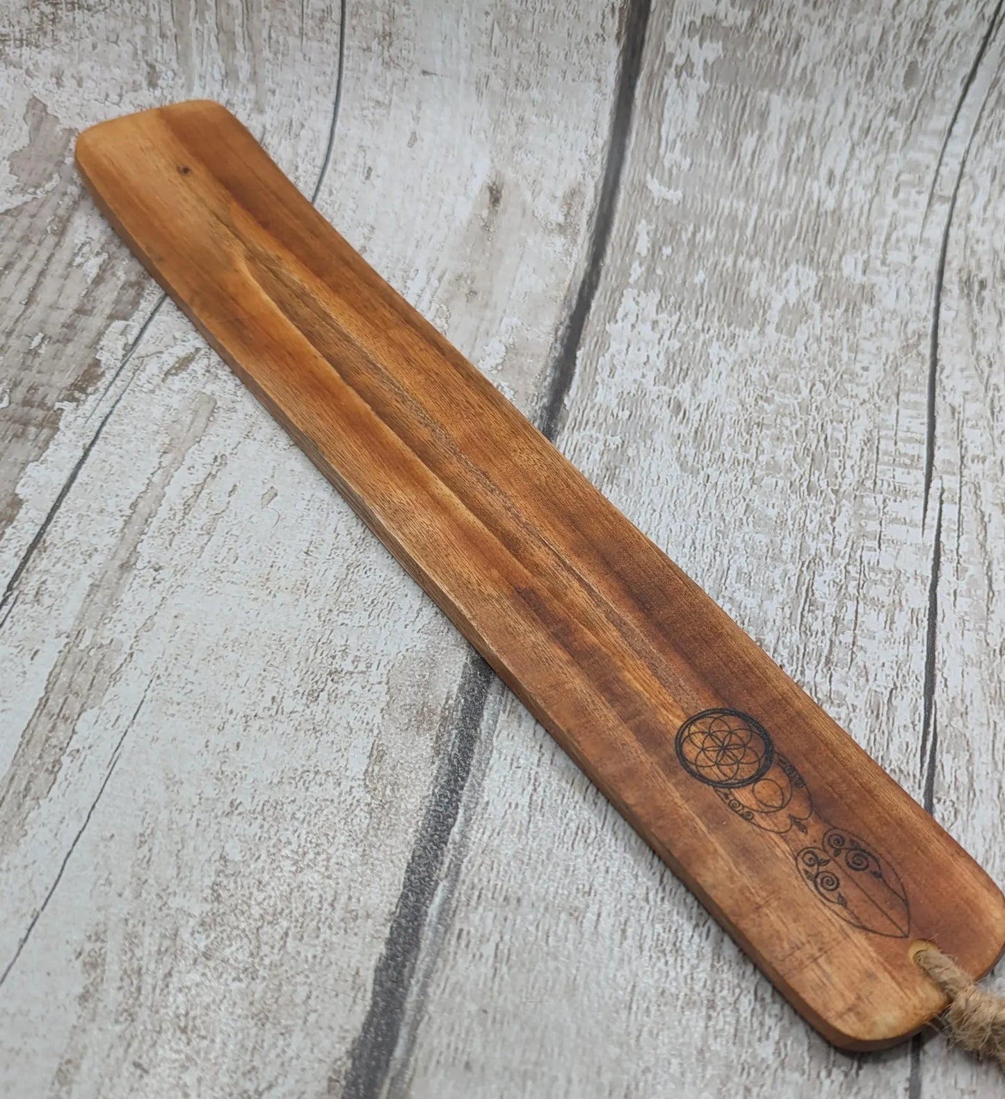 Recycled mango wood laser printed incense stick holders.