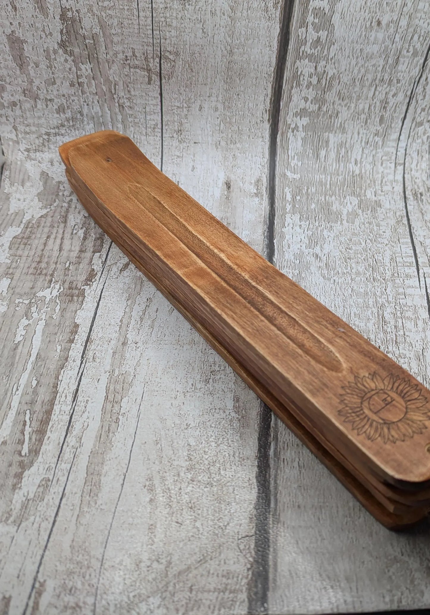 Recycled mango wood laser printed incense stick holders.