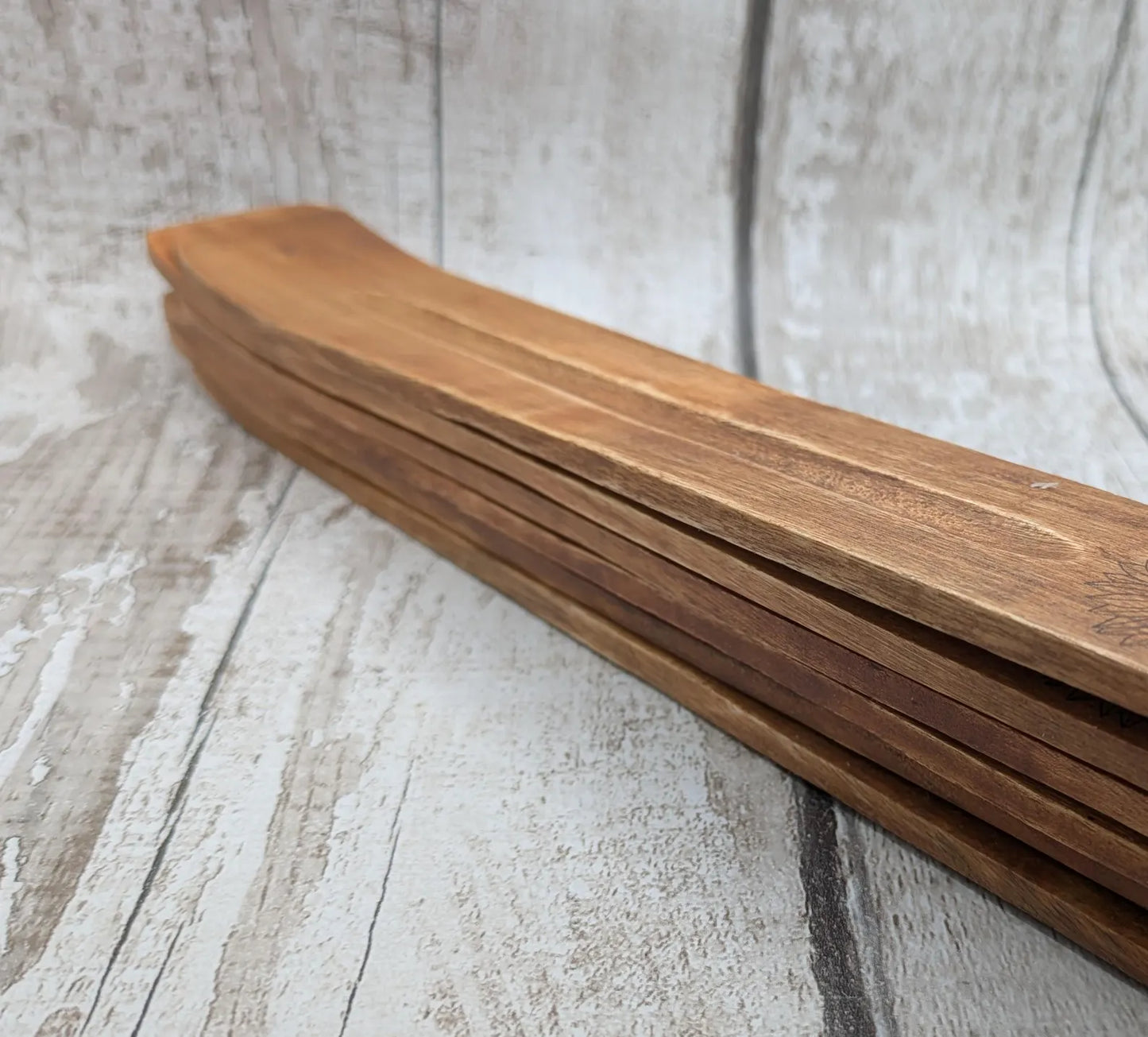 Recycled mango wood laser printed incense stick holders.