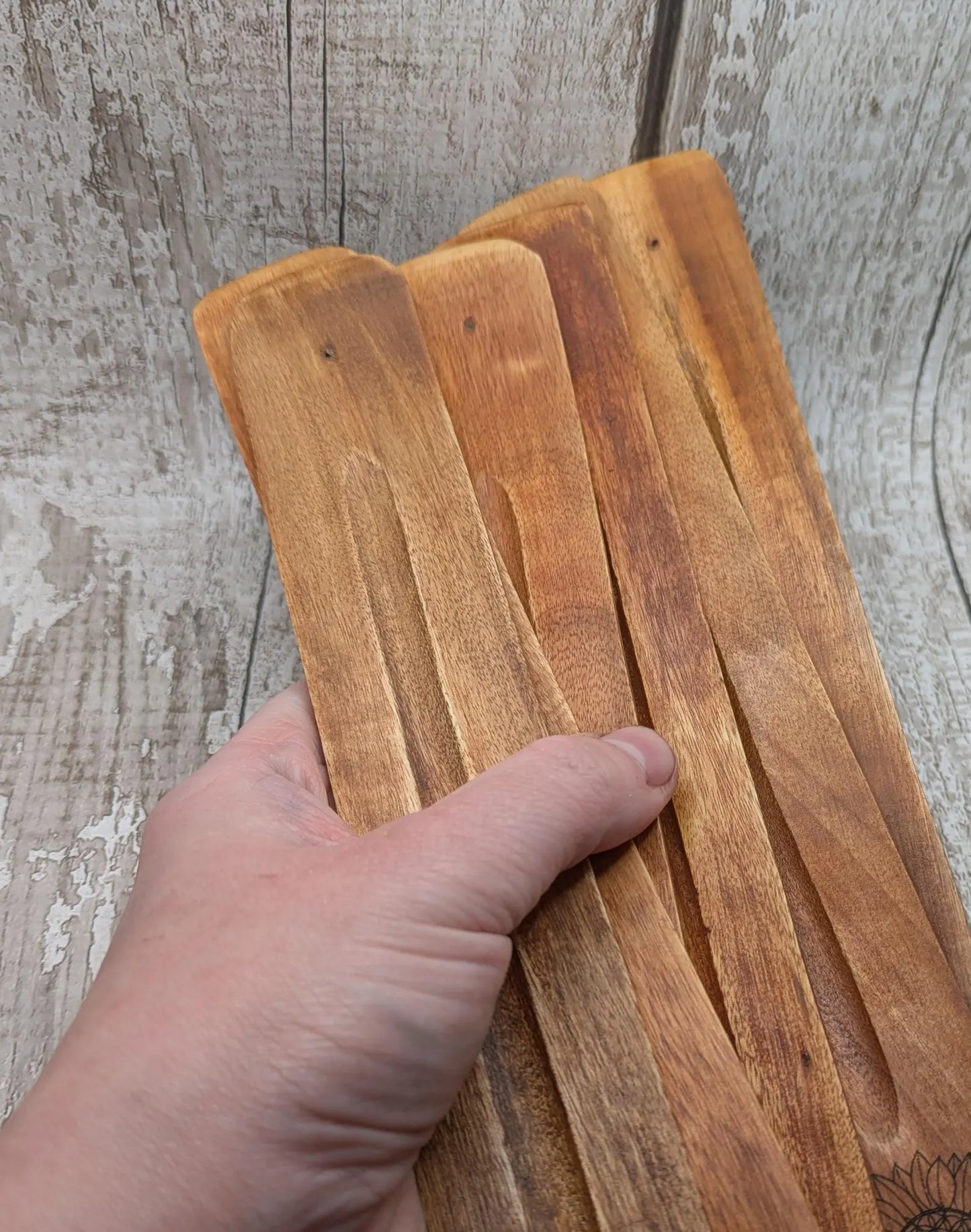 Recycled mango wood laser printed incense stick holders.