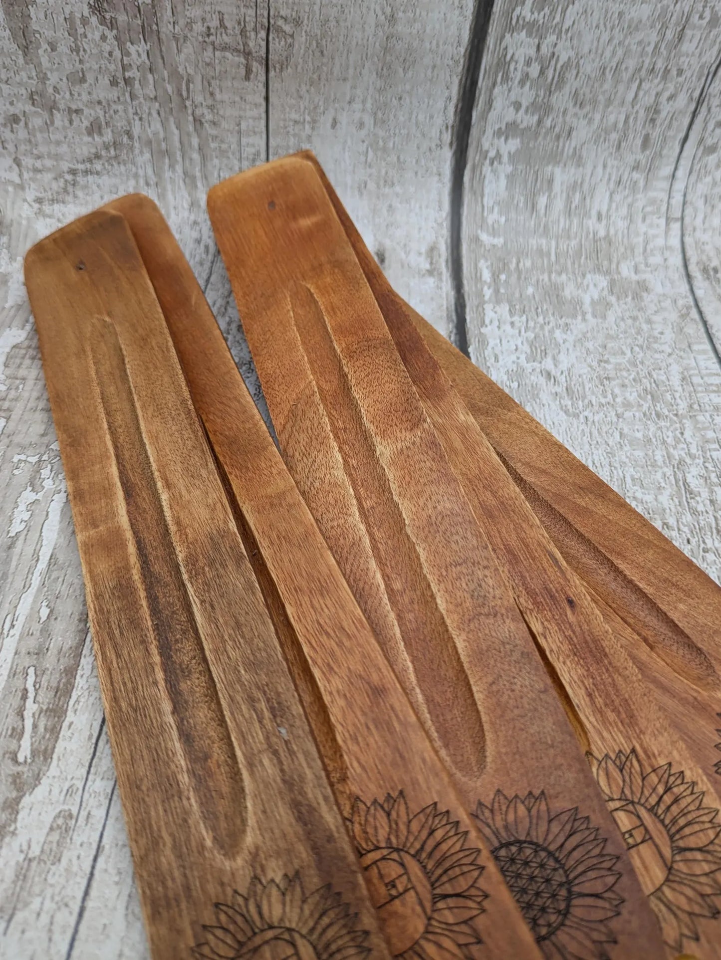 Recycled mango wood laser printed incense stick holders.