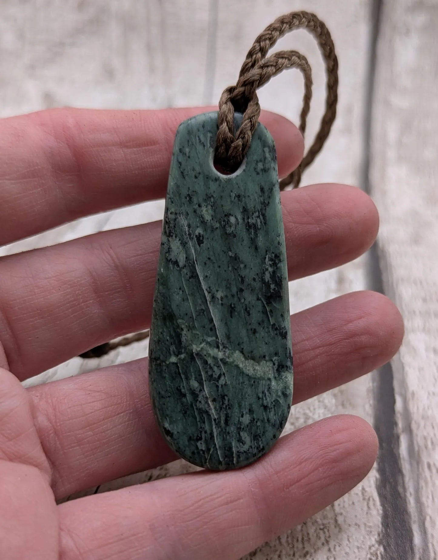New Zealand Pounamu jade Hei Toki adze styled pendant.
