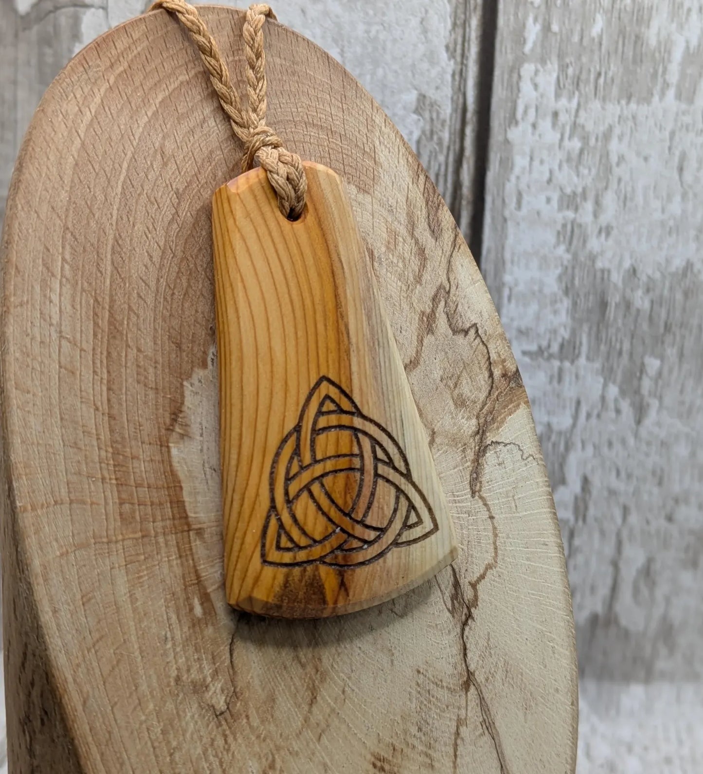 Yew wood triskelion laser printed pendant.