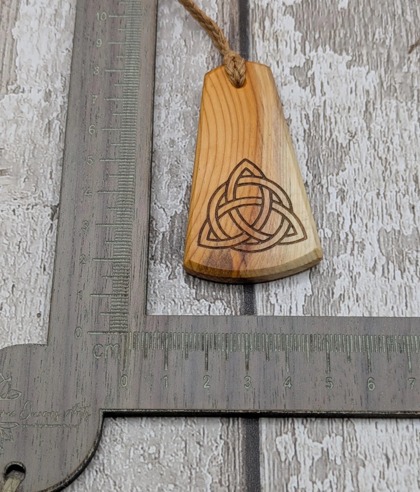 Yew wood triskelion laser printed pendant.