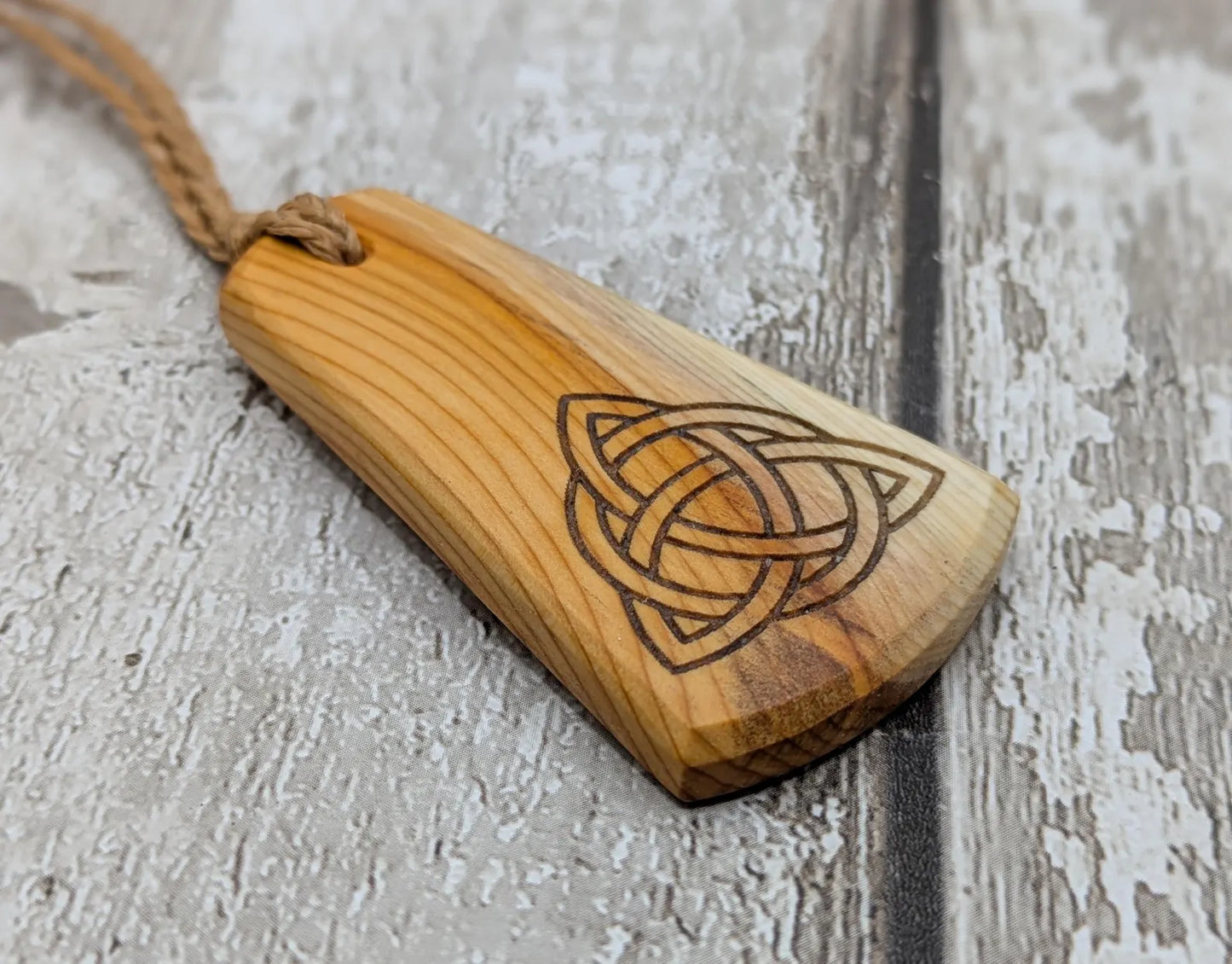 Yew wood triskelion laser printed pendant.