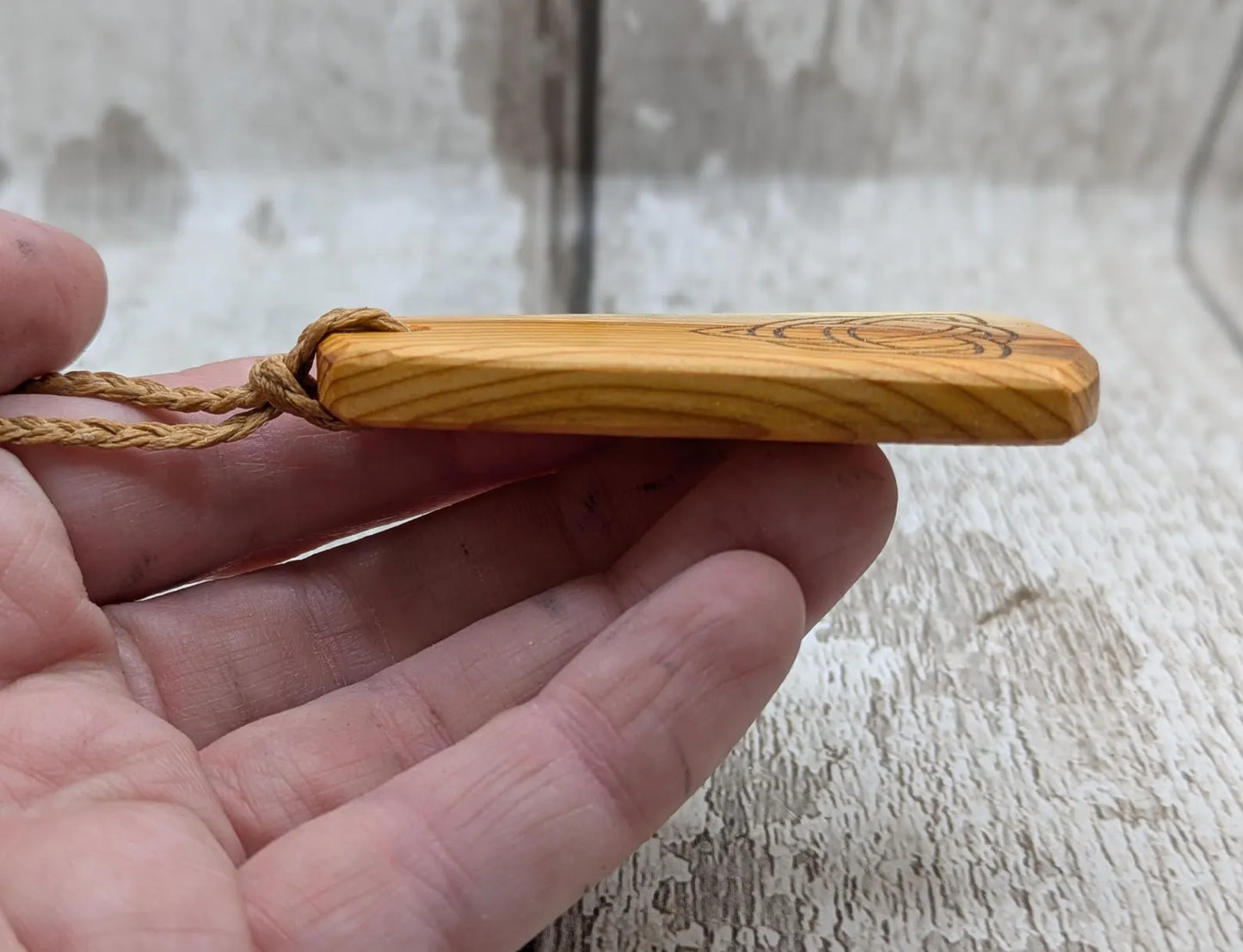 Yew wood triskelion laser printed pendant.