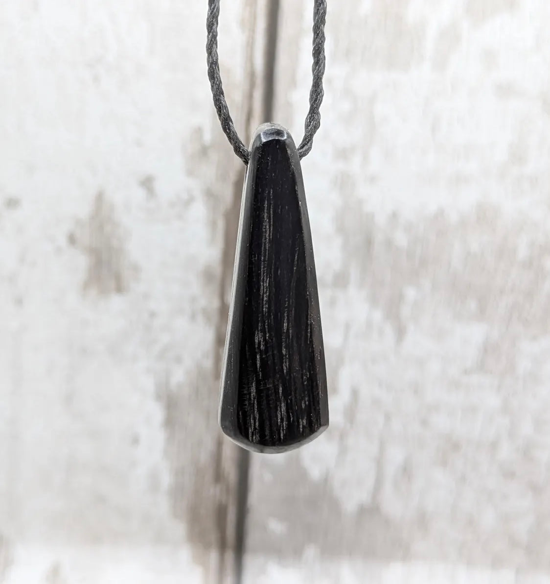 Fenland bog oak with Preseli bluestone roimata pendant.