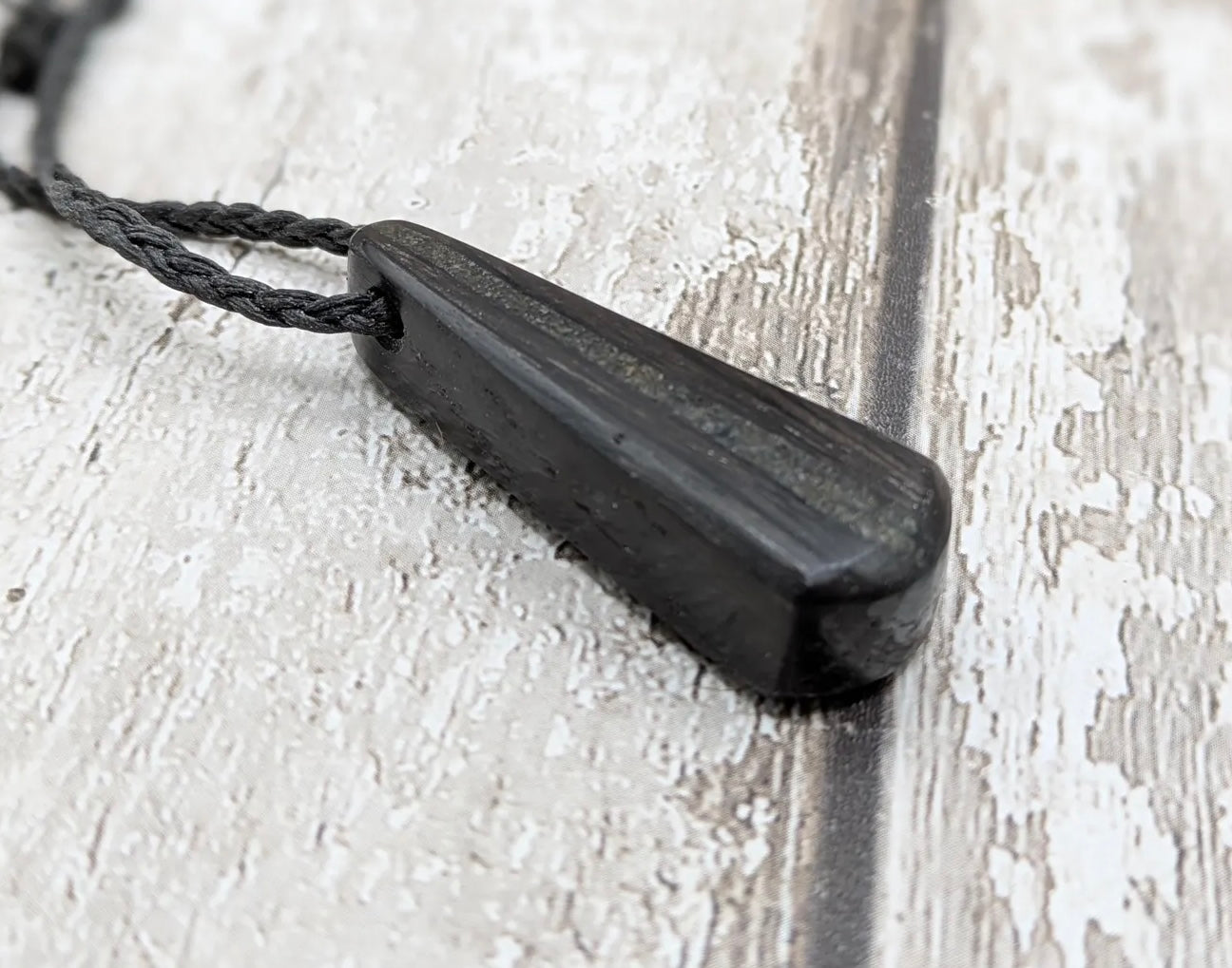Fenland bog oak with Preseli bluestone roimata pendant.