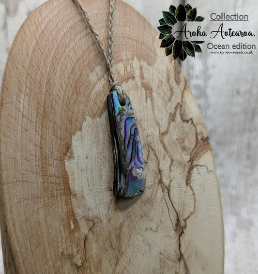 New Zealand rainbow pāua shell pendant on a churn chain.