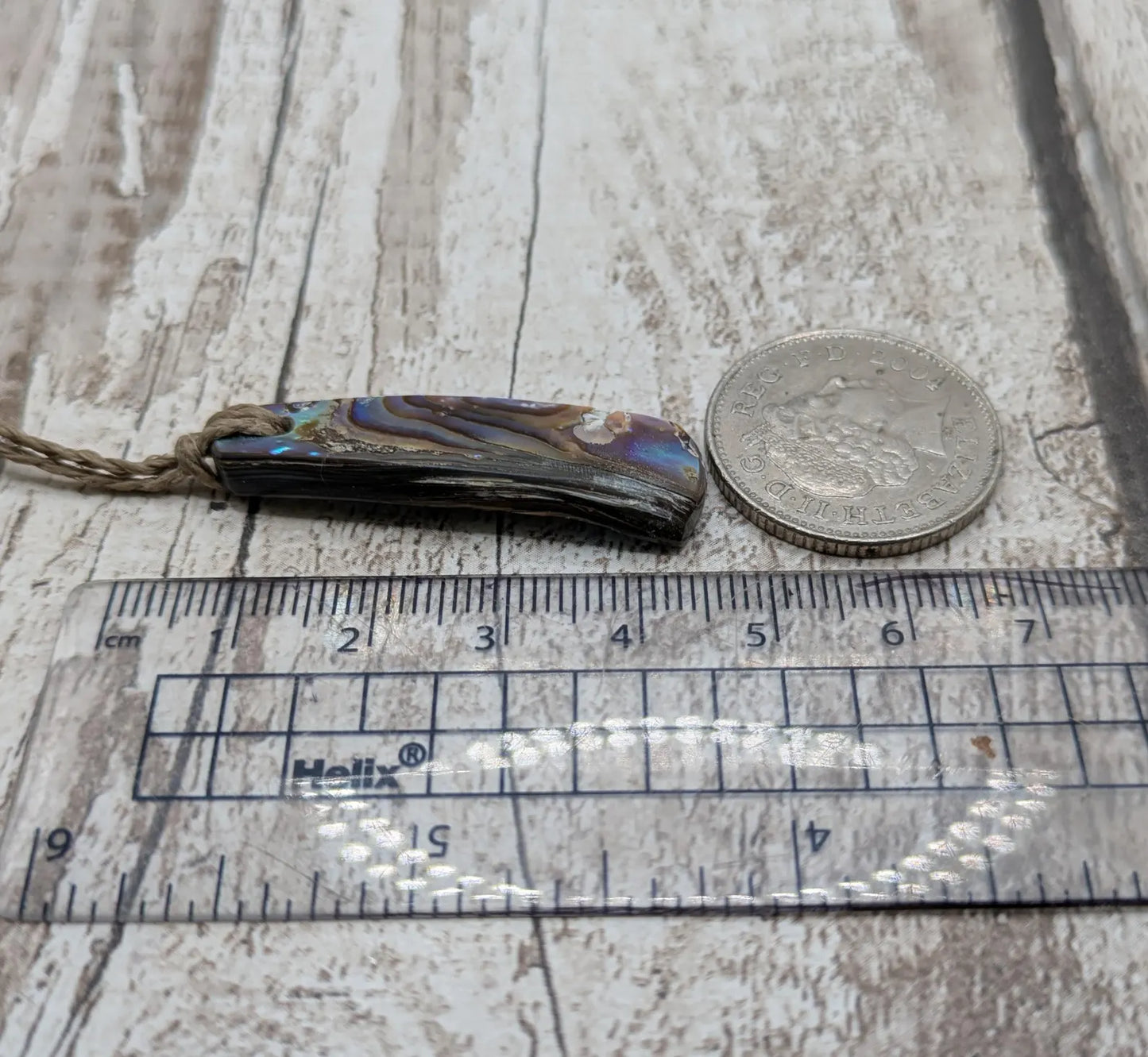 New Zealand rainbow pāua shell pendant on a churn chain.