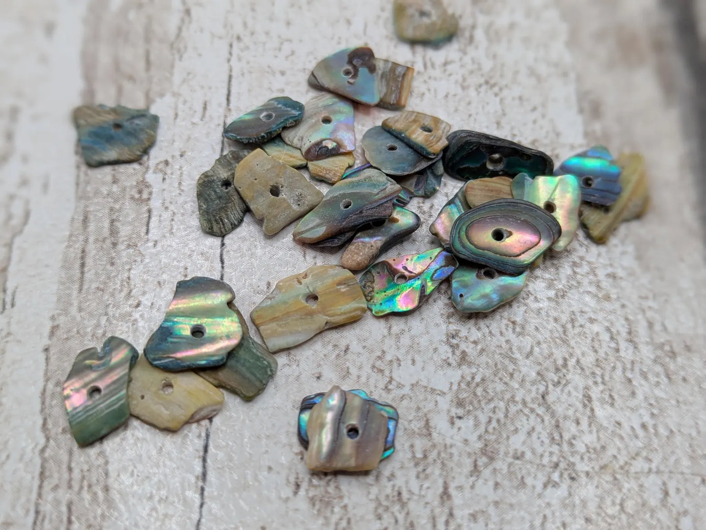 Tiny New Zealand centre drilled abalone Pāua shell beads.