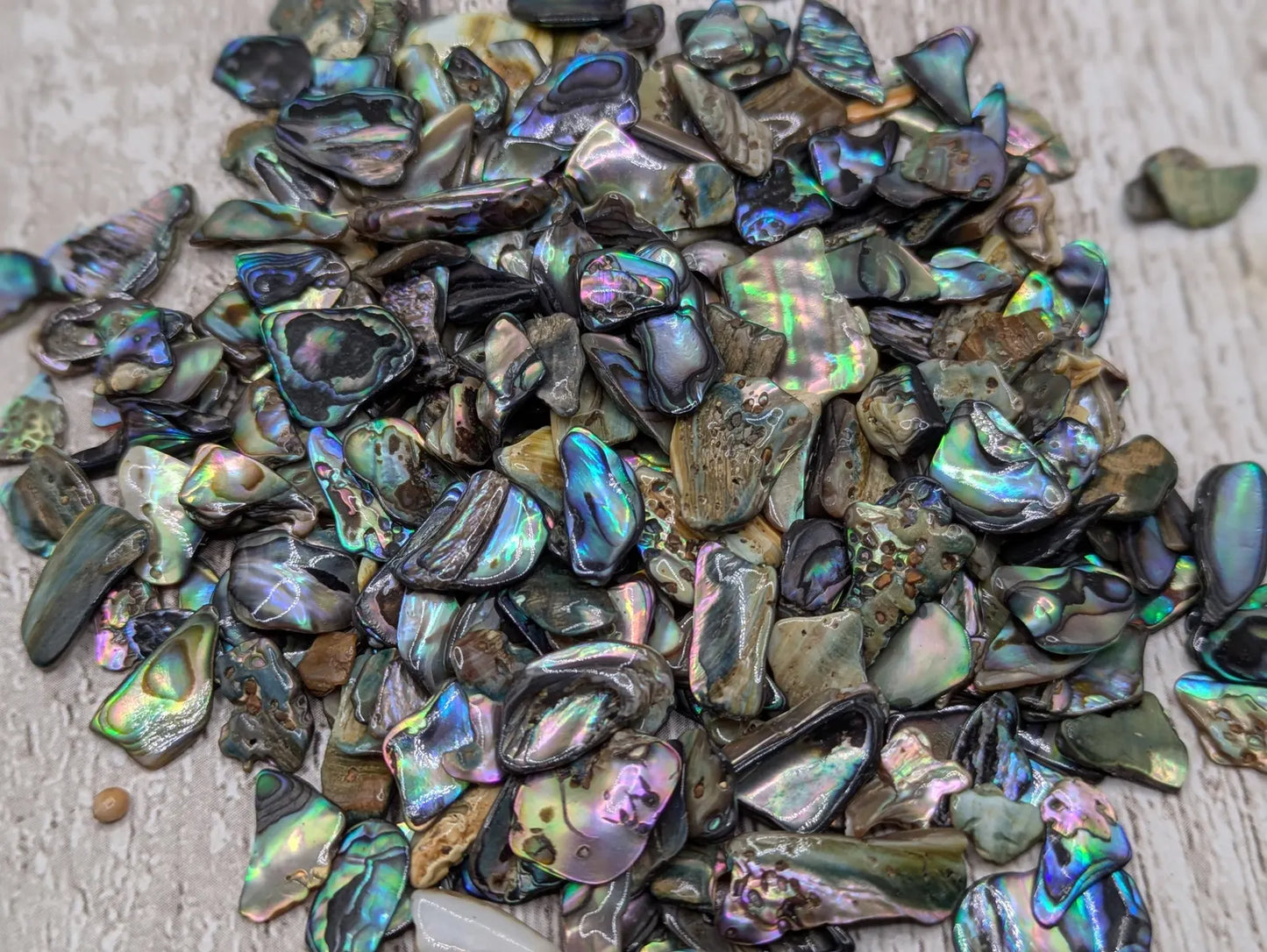 1 pouch New Zealand rainbow pāua abalone shell tumbled chips.