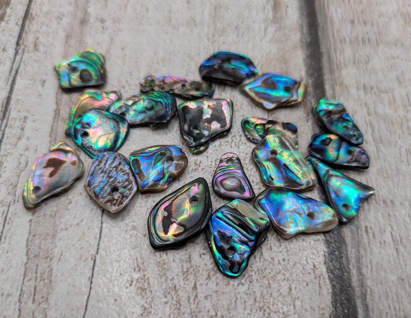 Tiny polished new Zealand rainbow pāua abalone shell beads.
