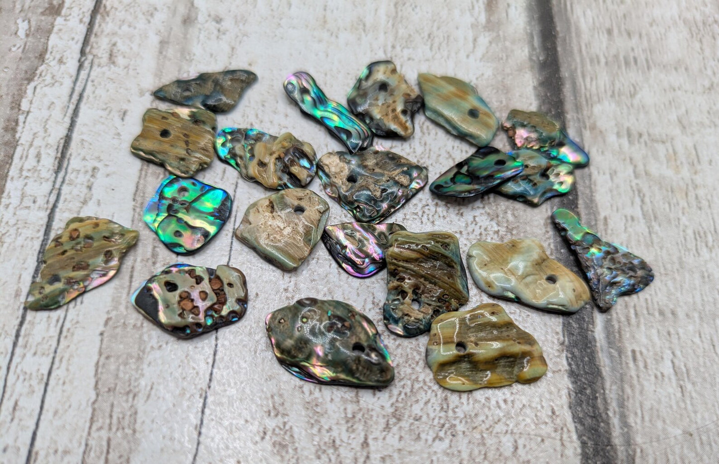 Tiny polished new Zealand rainbow pāua abalone shell beads.