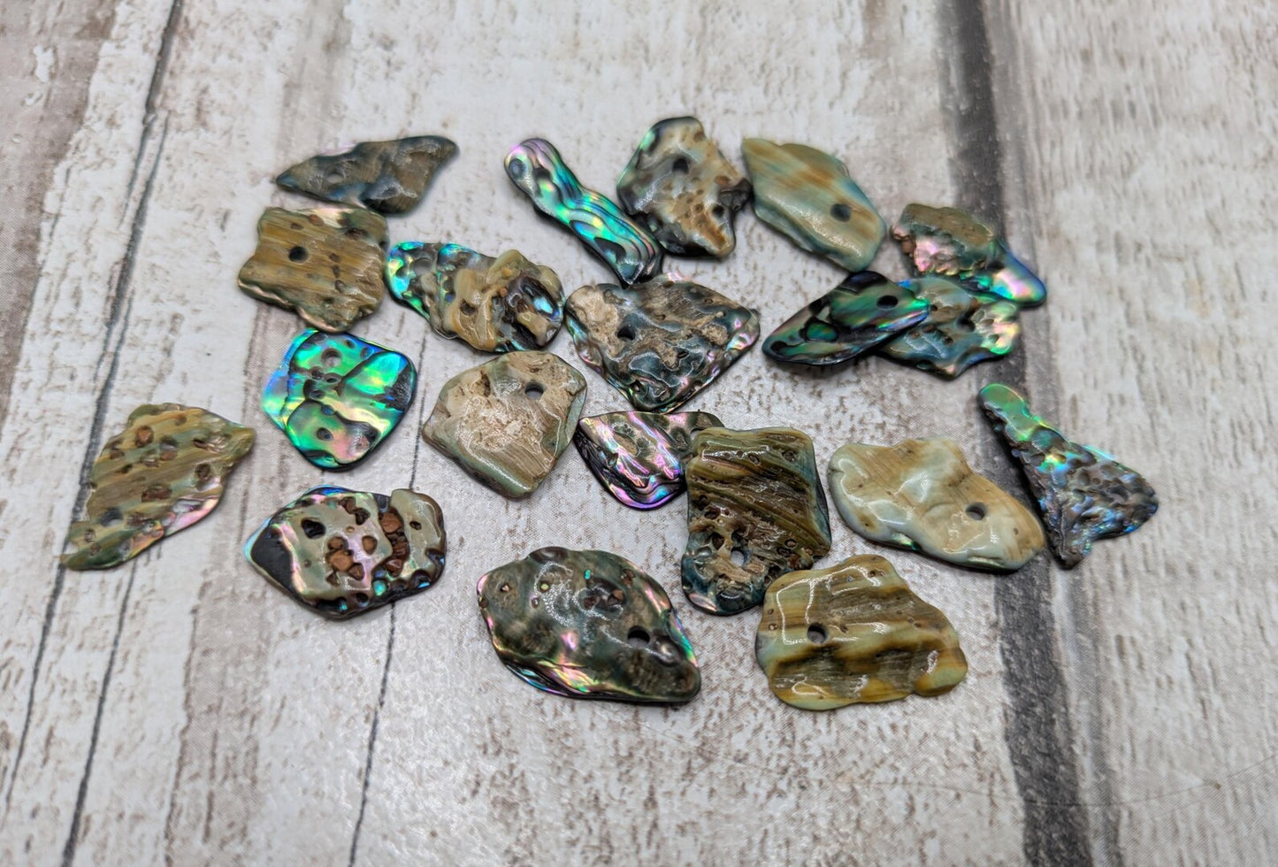 Tiny polished new Zealand rainbow pāua abalone shell beads.