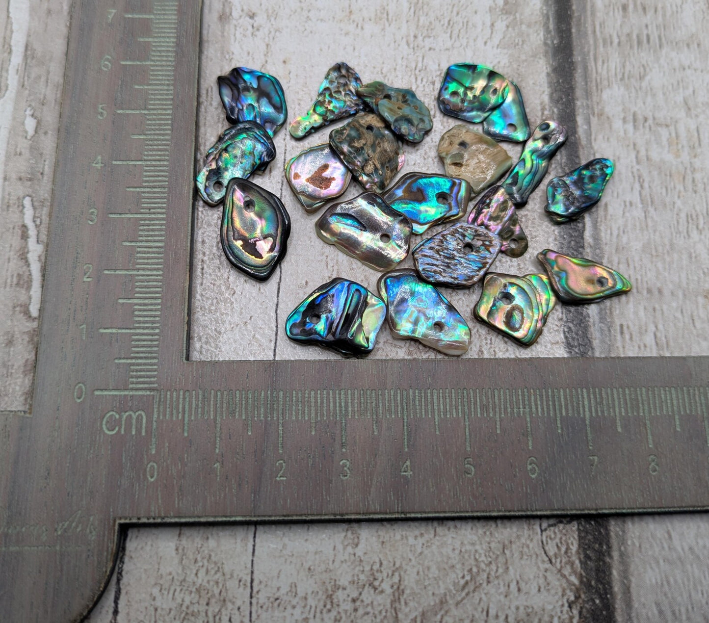 Tiny polished new Zealand rainbow pāua abalone shell beads.