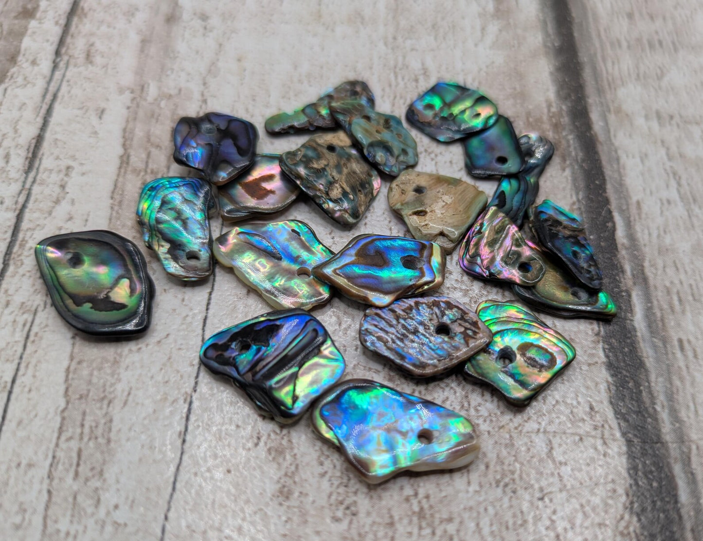 Tiny polished new Zealand rainbow pāua abalone shell beads.