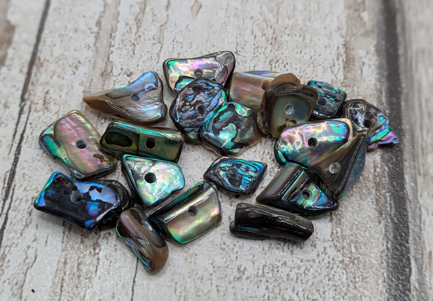 20 central drilled new Zealand rainbow pāua abalone shell beads.