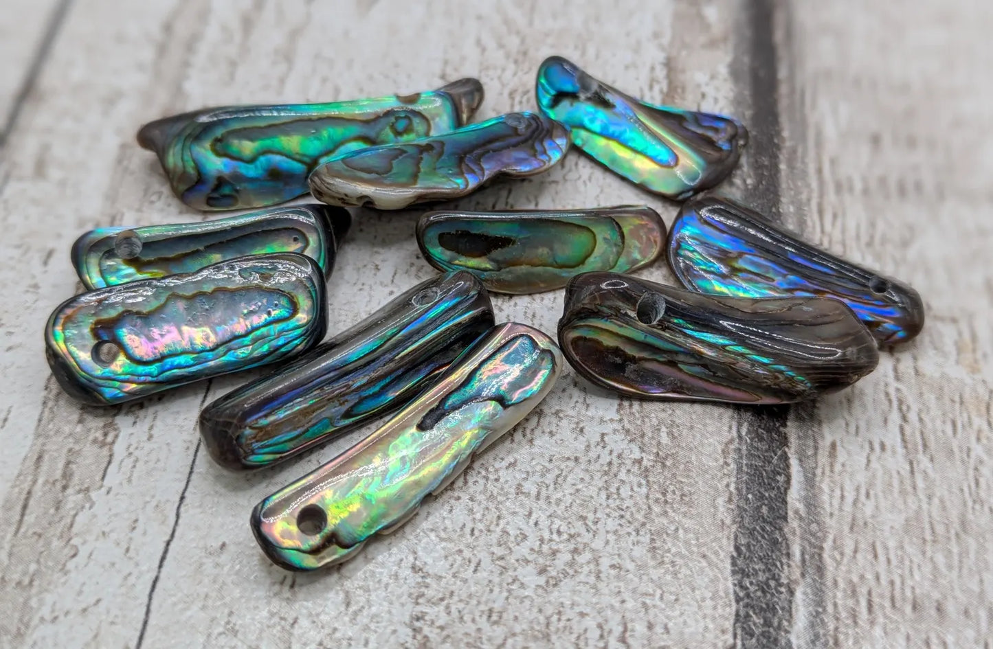 20 central drilled new Zealand rainbow pāua abalone shell beads.