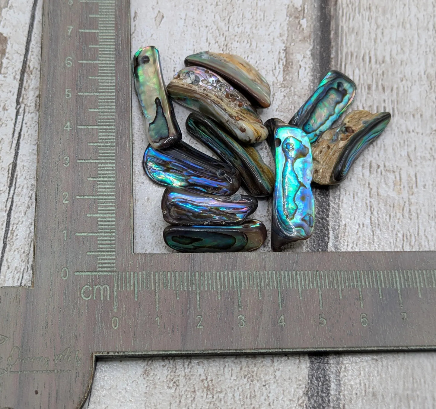 20 central drilled new Zealand rainbow pāua abalone shell beads.