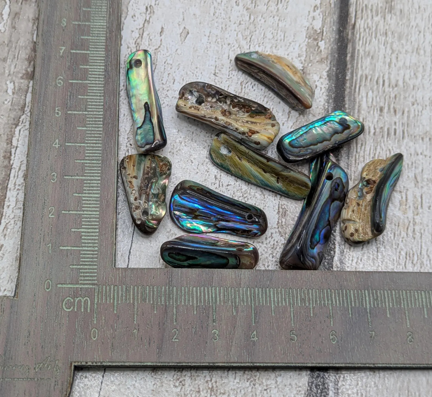 20 central drilled new Zealand rainbow pāua abalone shell beads.