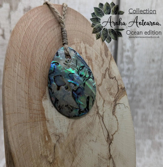 Carved NZ Pāua Shell Oval Pendant – Handcrafted Rainbow Abalone Jewel, Ocean-Inspired fashion, iridescent amulet.