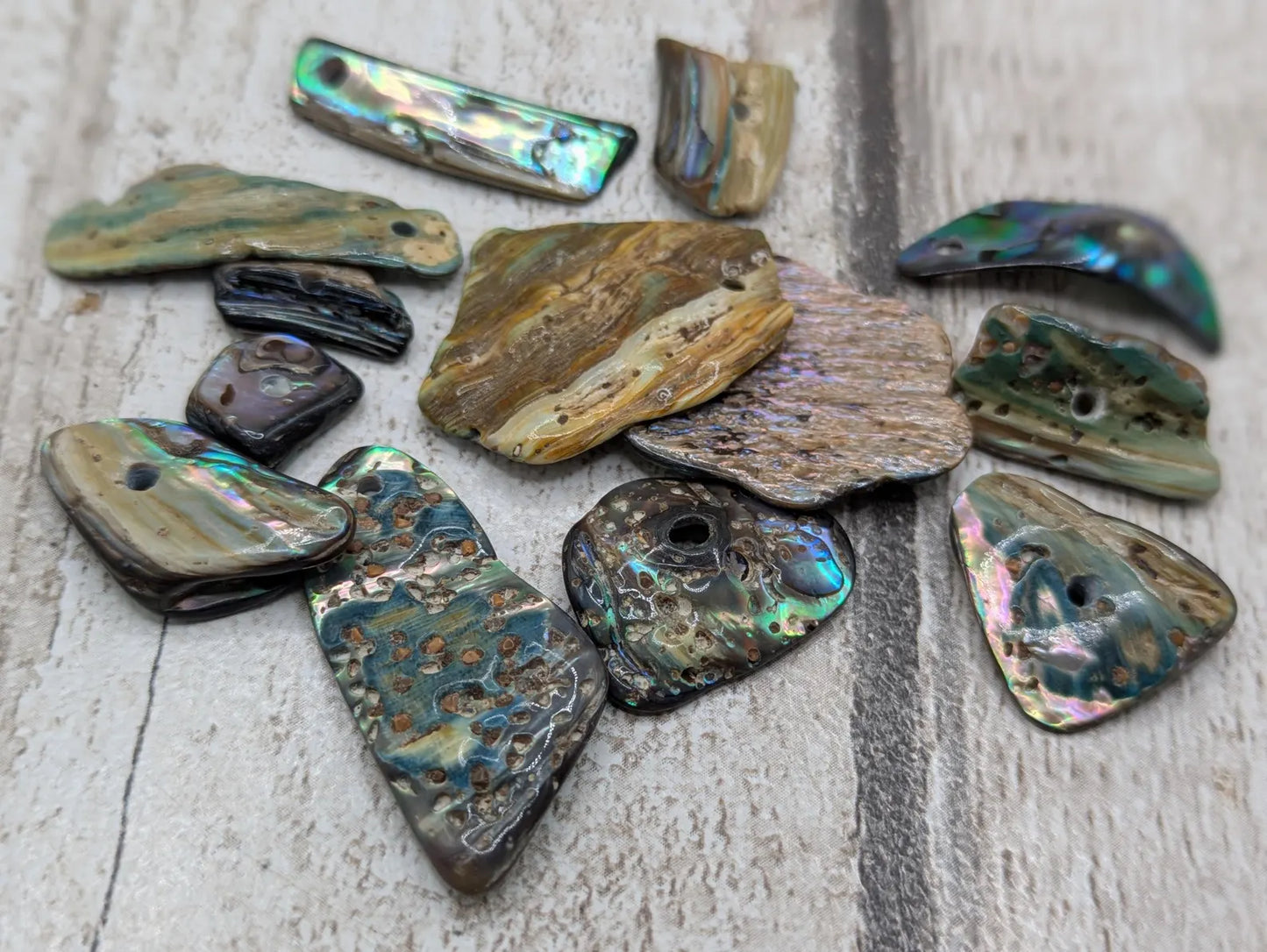 13 New Zealand rainbow pāua abalone shell odd beads.