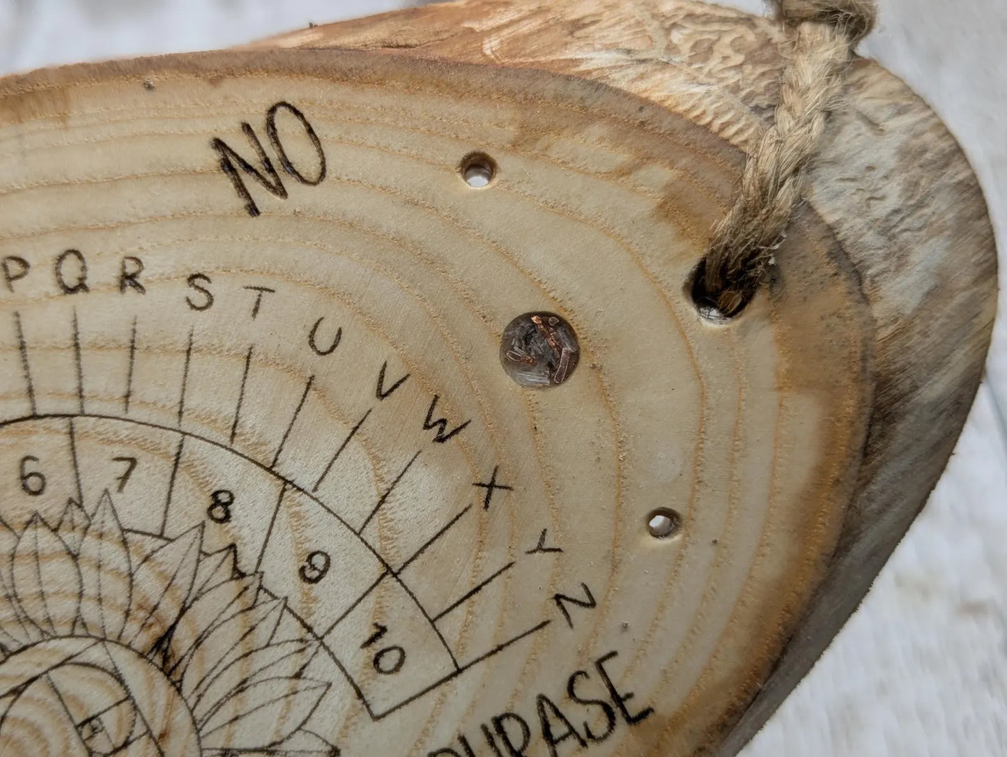Ash wood laser printed pendulum dowsing board with sunflower detail.