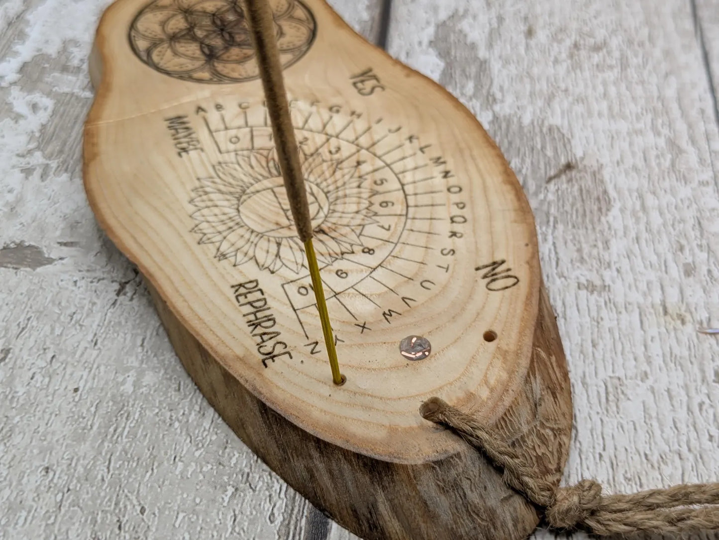 Ash wood laser printed pendulum dowsing board with sunflower detail.