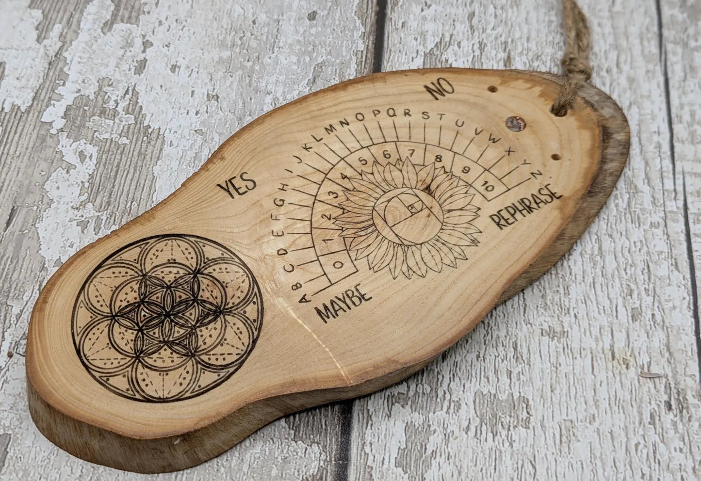 Ash wood laser printed pendulum dowsing board with sunflower detail.