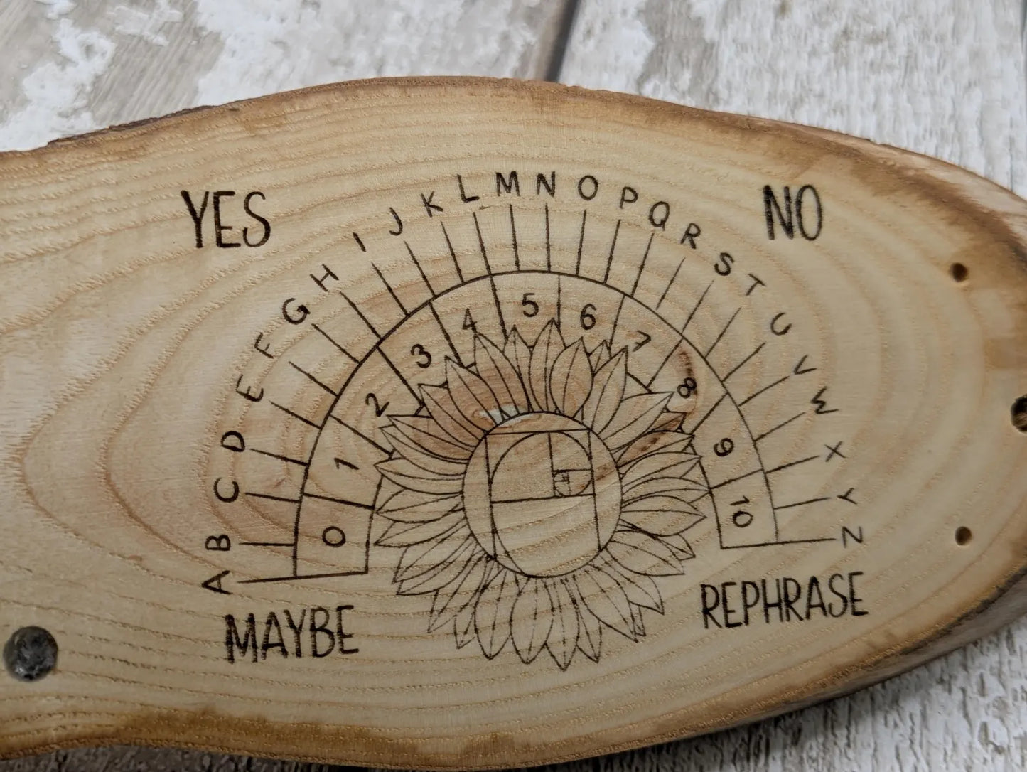 Ash wood pendulum dowsing pendulum board laser printed, with sunflower design.