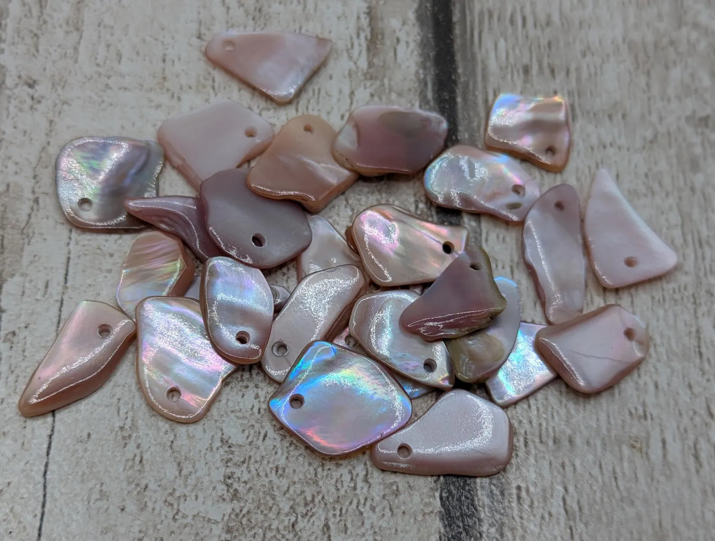 New Zealand top drilled tumbled pink fresh water mussel shell.