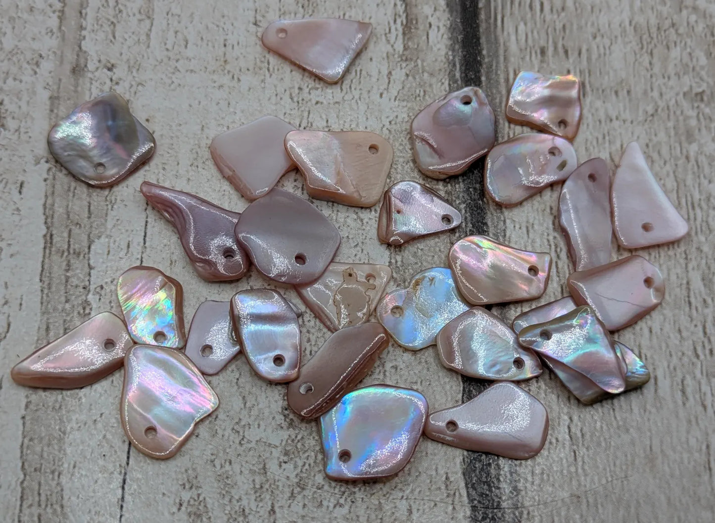 New Zealand top drilled tumbled pink fresh water mussel shell.